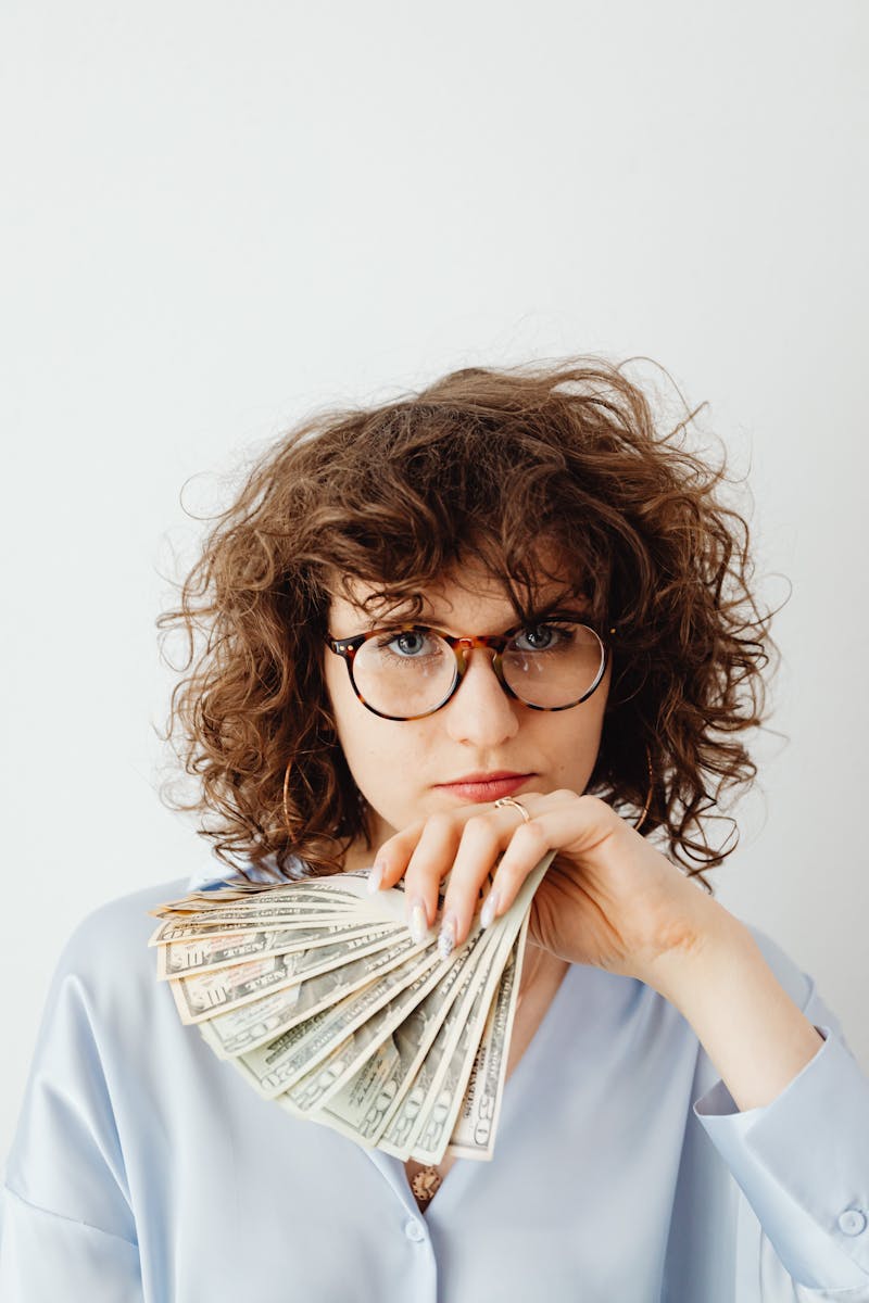 Curly-Haired Woman Holding Paper Money
